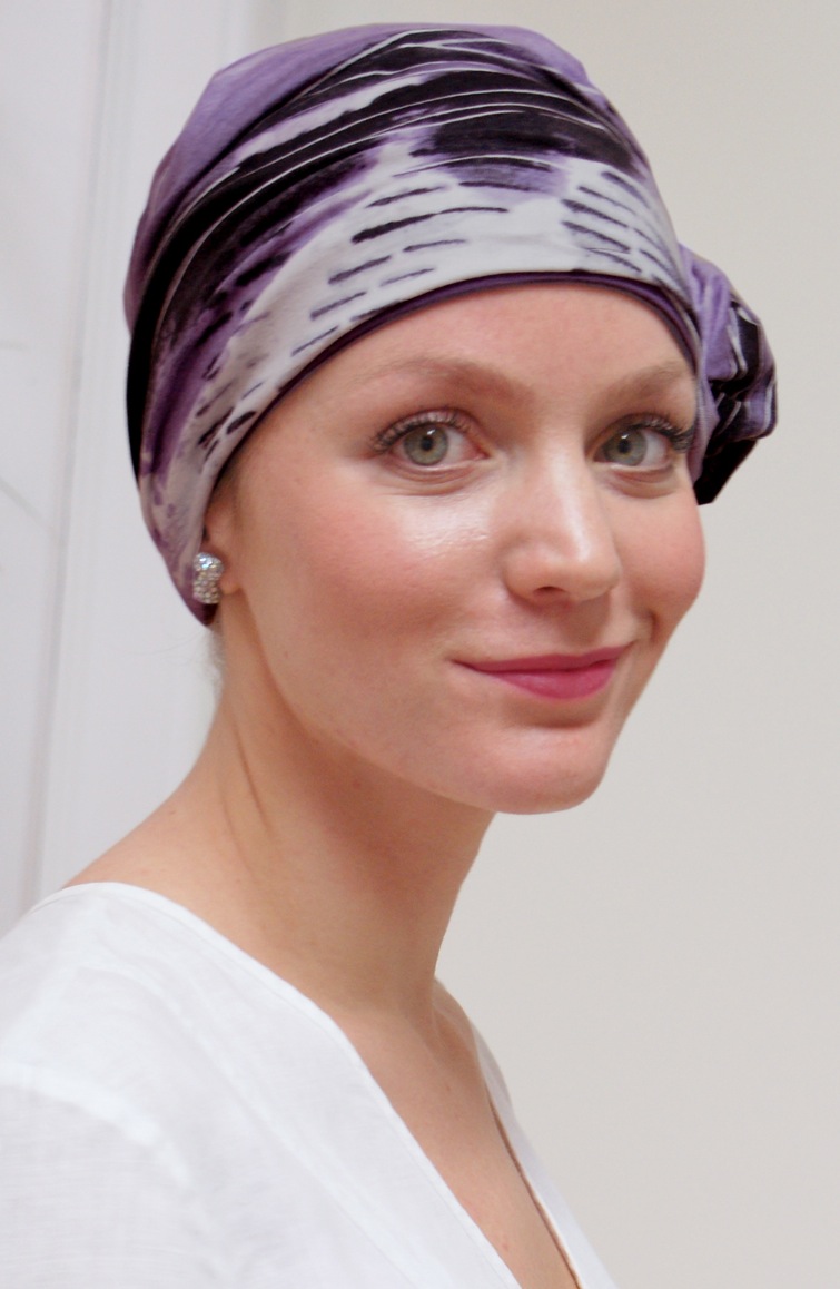 close up of woman smiling wearing mauve chemo turban