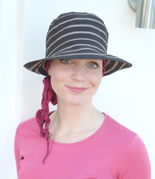 woman wearing brown summer hat over bandana scarf for female hair loss