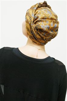 Back view of gold silk evening head scarf worn with black dress