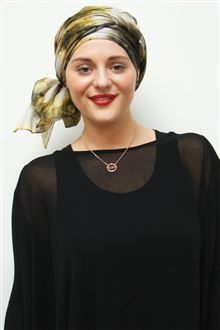 Golden silk head scarf wrapped as a turban on model with black evening dress