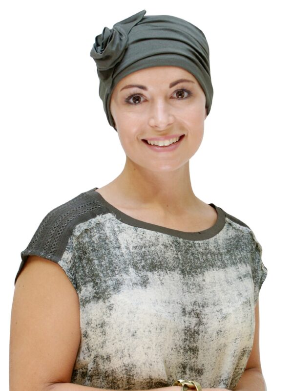 green chemo hat worn by young woman