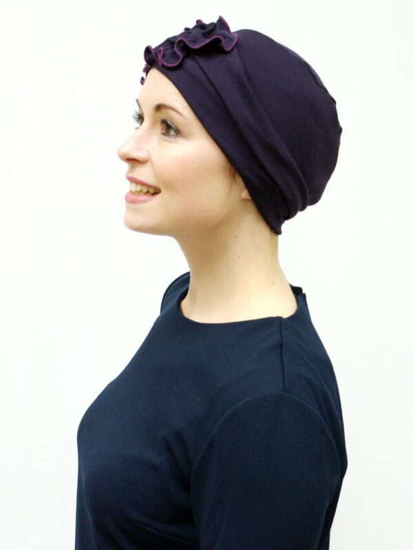 purple chemo hat in soft jersey worn by woman