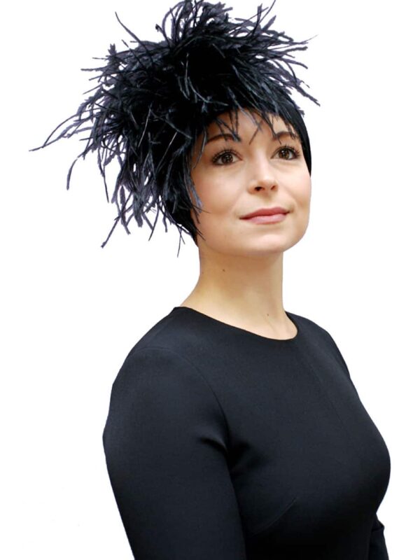 woman wearing special occasion black turban with feathers