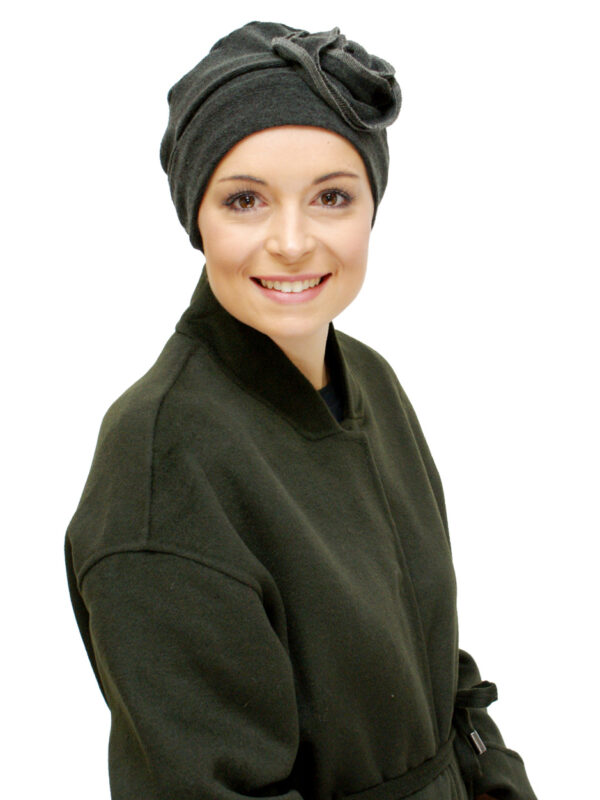 green winter chemo hair loss hat worn by young woman