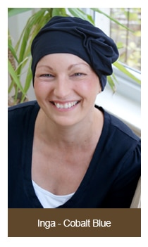 woman smiling wearing grey fashion turban in her house