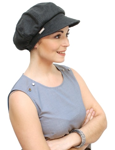 young woman wearing black linen cap