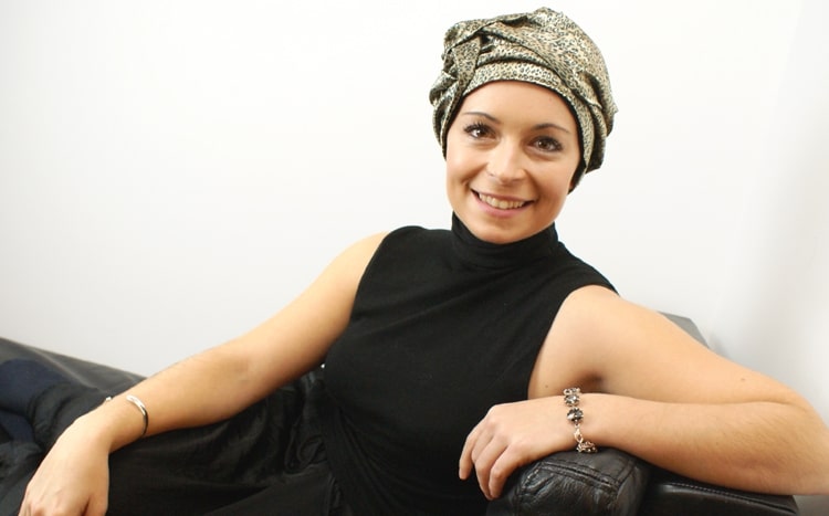 woman out for the evening in chemo turban