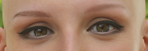 close up of woman's eyes with faux make-up eyebrows