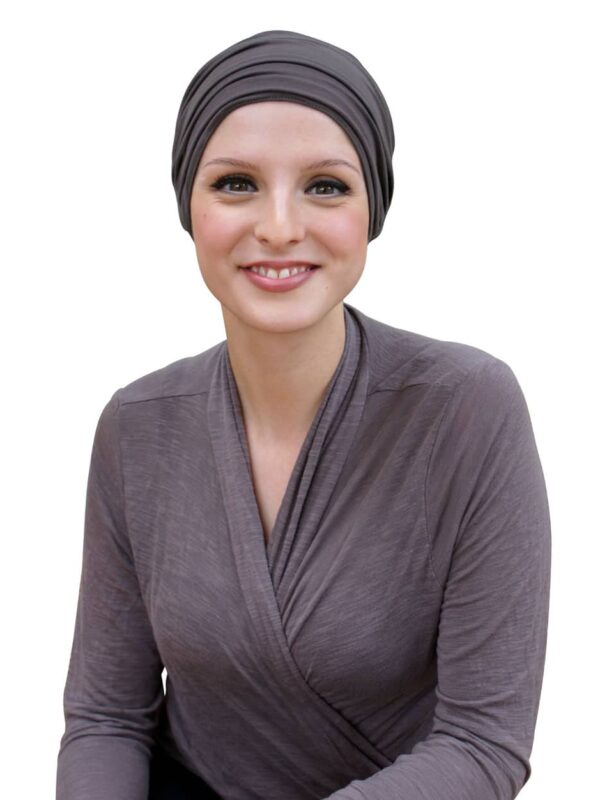 young woman wearing chemo hat