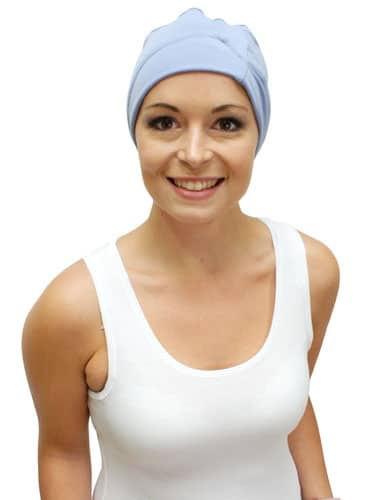 young woman wearing sleep hat for hair loss