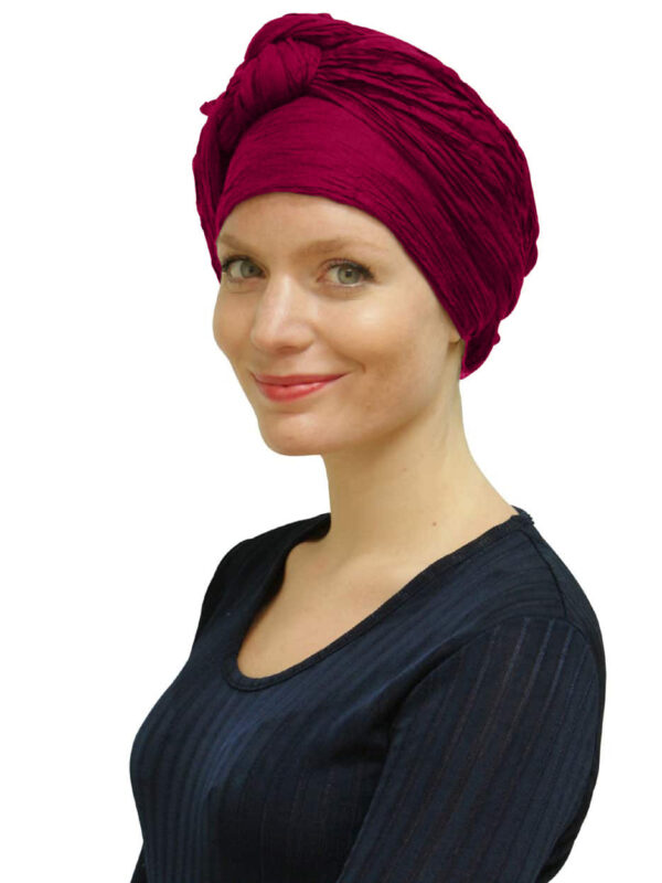 Woman wearing raspberry head scarf turban