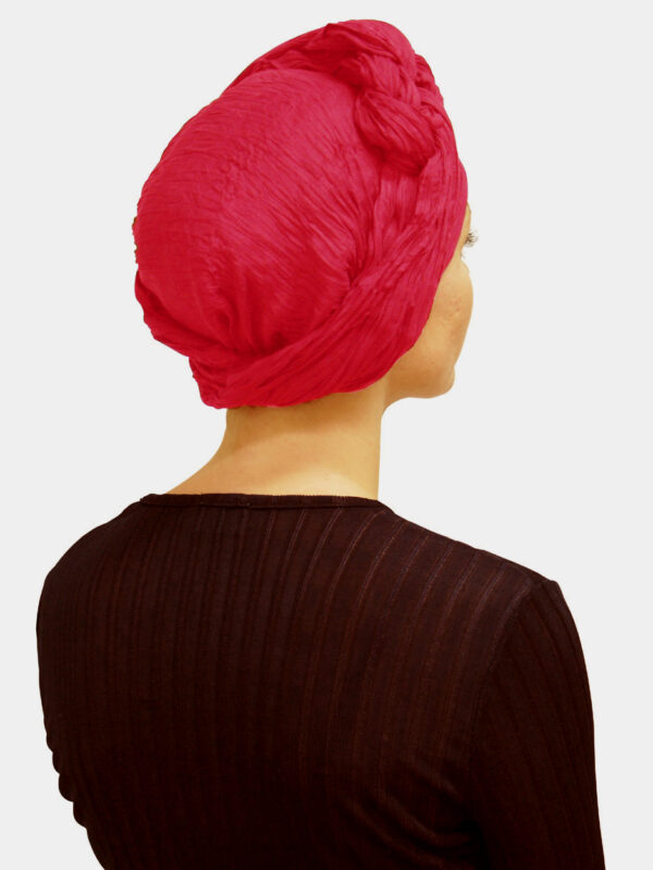 Bright pink head scarf worn as a woman's turban