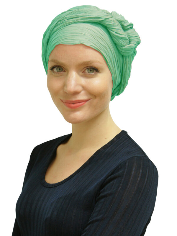 Woman wearing green head scarf turban