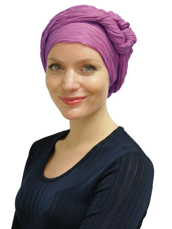 young woman wearing purple head scarf as a turban