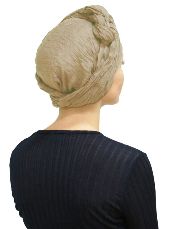 Woman wearing a stylish head wrap scarf.