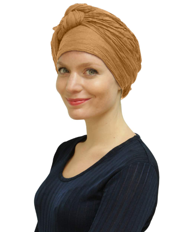 Woman wearing dark sand head scarf turban