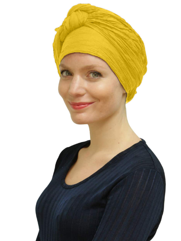 Woman wearing summer yellow head scarf turban