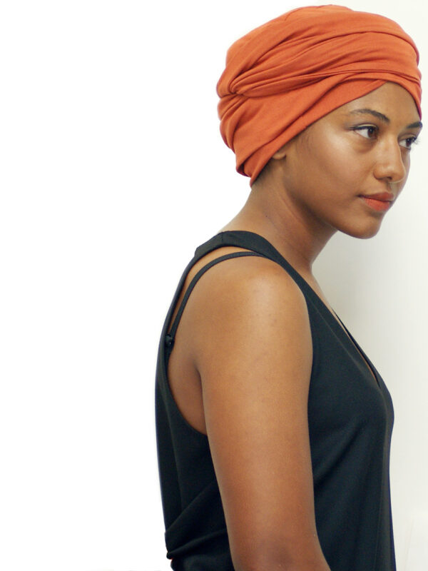 woman of colour wearing orange head wrap