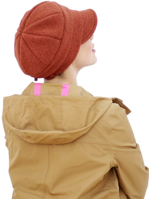 woman wearing warm orange wool cap
